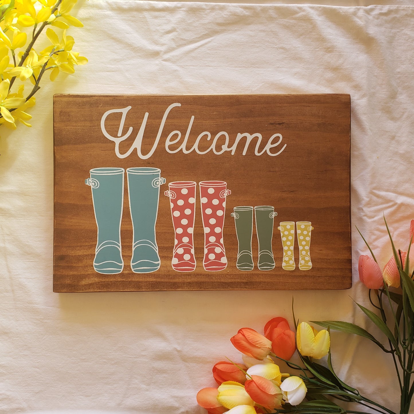 Welcome sign with rainboots