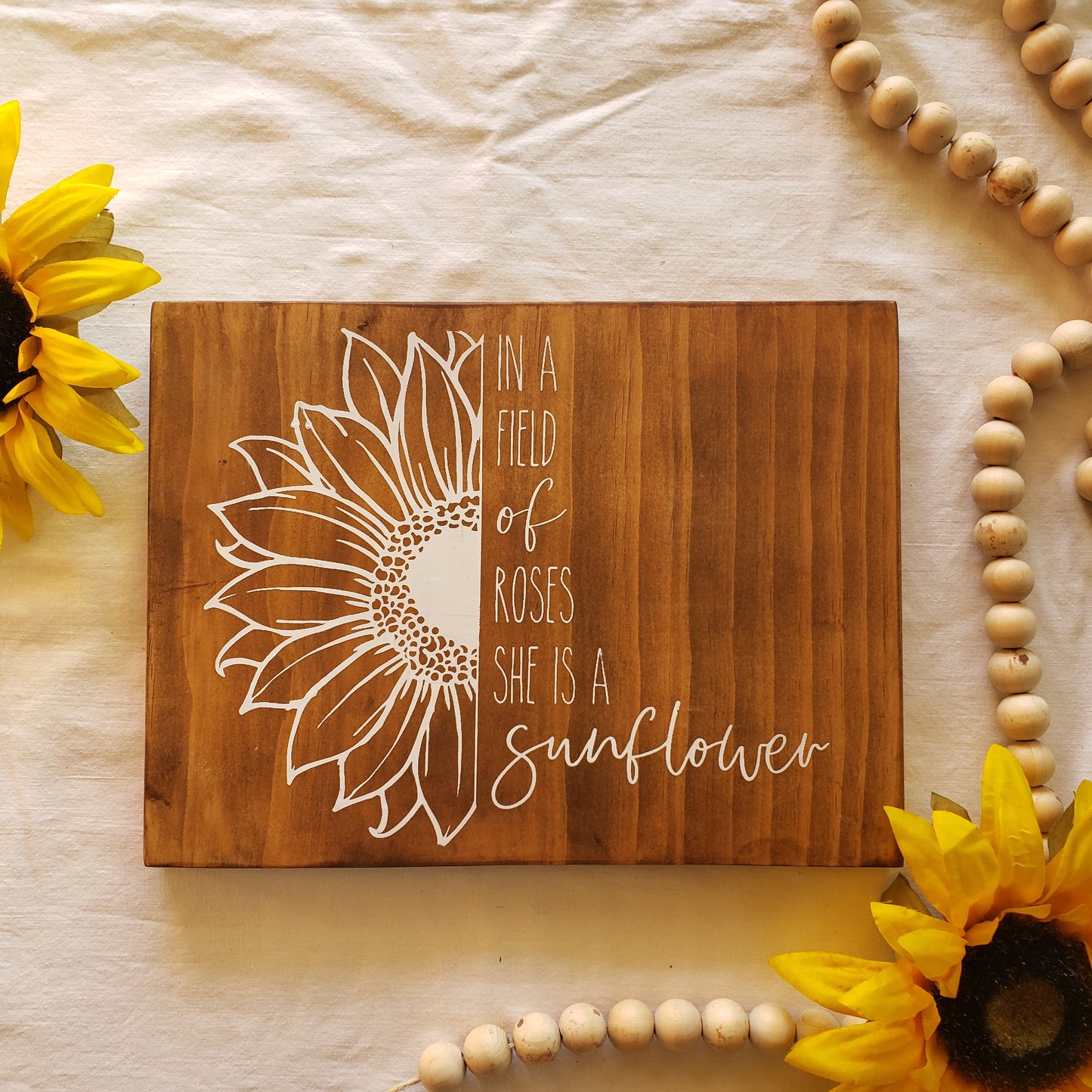 In a field of roses she is a Sunflower