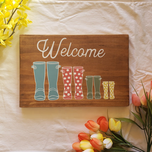 Welcome sign with rainboots